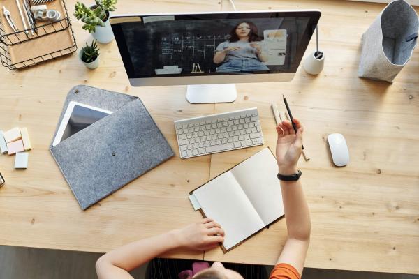 top view photo of girl watching through imac 4144294 1